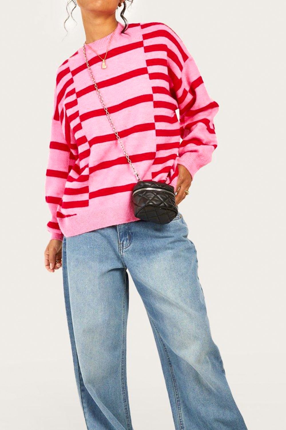 Colorblock stripe knit sweater in hot pink with balloon sleeves and crew neck.