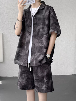Men's dark gray camouflage short sleeve shirt and drawstring shorts set.
