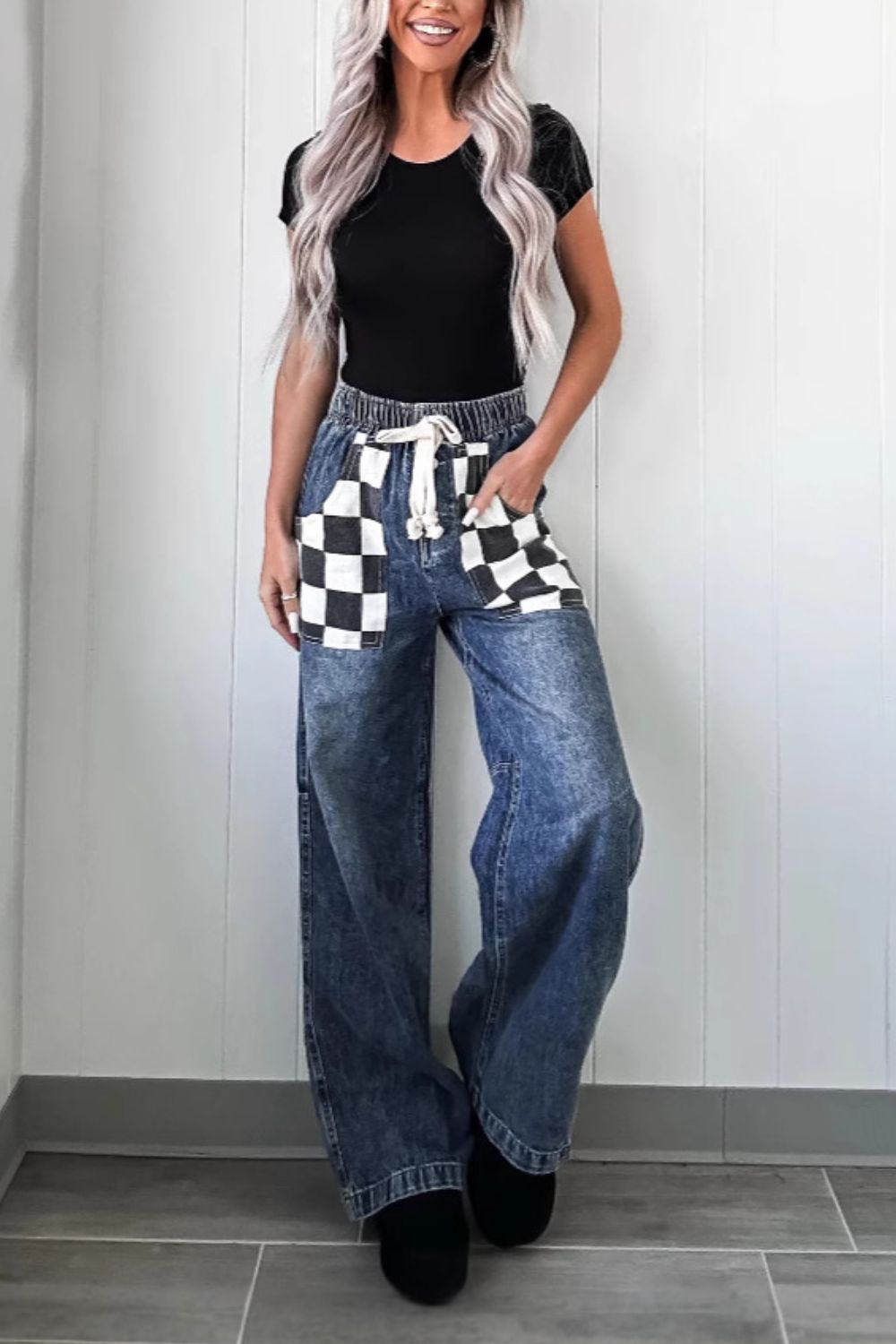 Checkerboard pocket wide-leg jeans in medium acid wash denim with drawstring waist.
