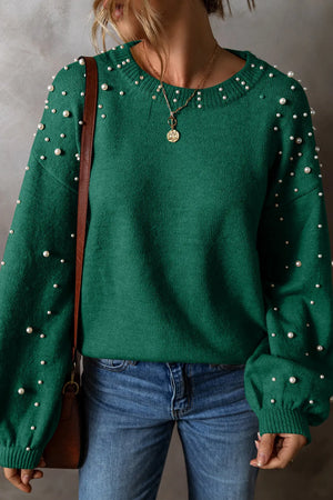Dark green knit sweater with pearl embellishments on the neckline and sleeves.