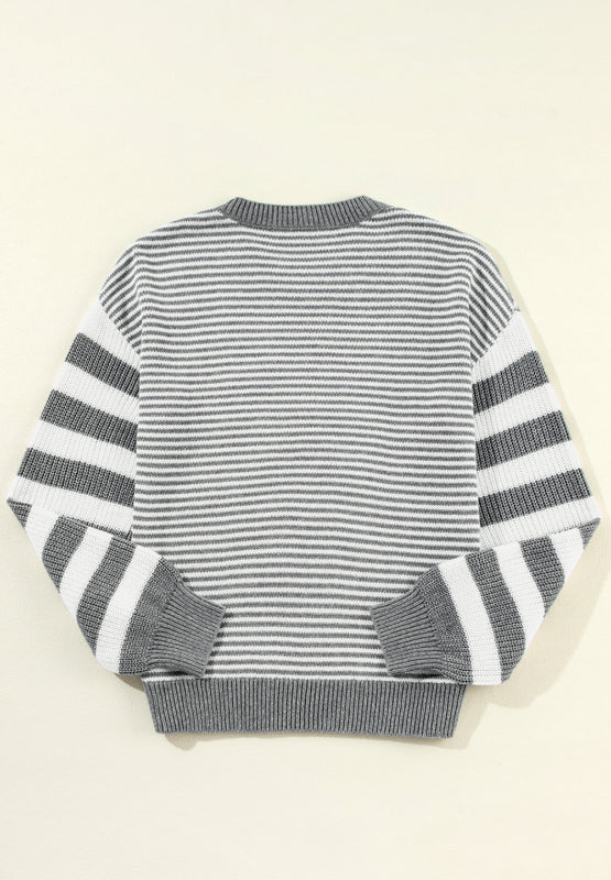Gray and white striped knit sweater with crew neck and ribbed cuffs and hem.