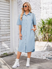 Light blue denim shirtdress with short sleeves, button front, chest pocket, and asymmetric hemline.