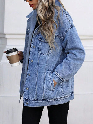 Oversized washed blue denim jacket with button front and pockets.