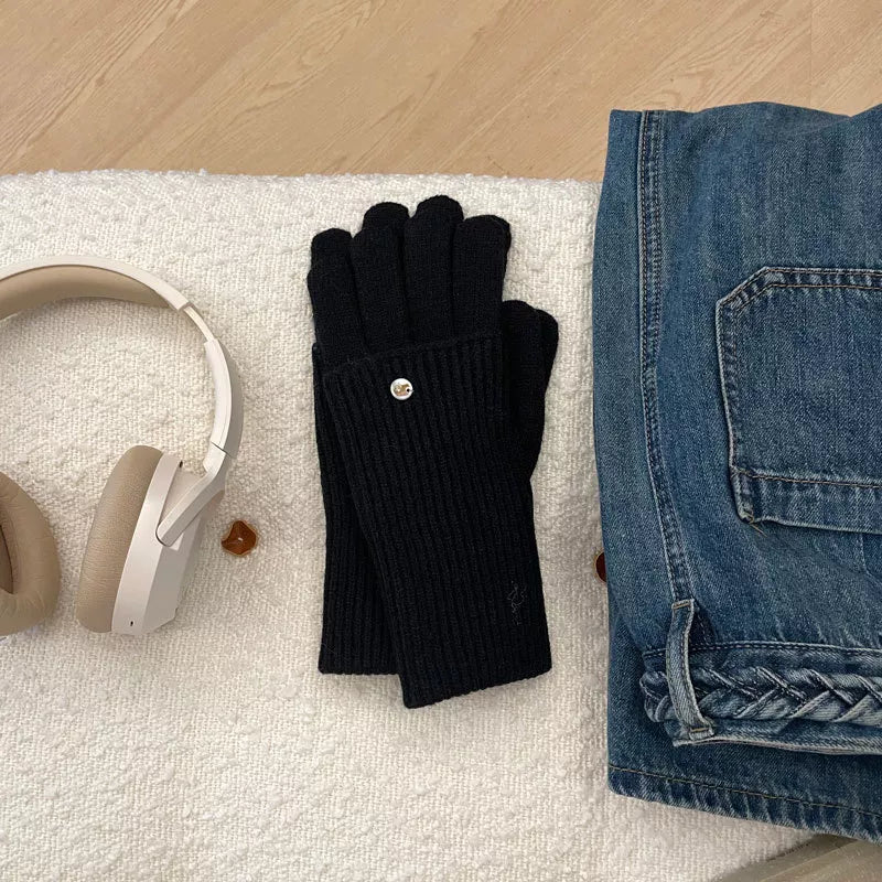 Black ribbed knit convertible gloves with a button detail and touchscreen capability.