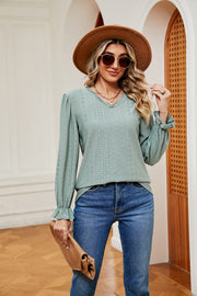 Perforated sleeve blouse in Gum Leaf with ruffle cuffs and V-neckline.