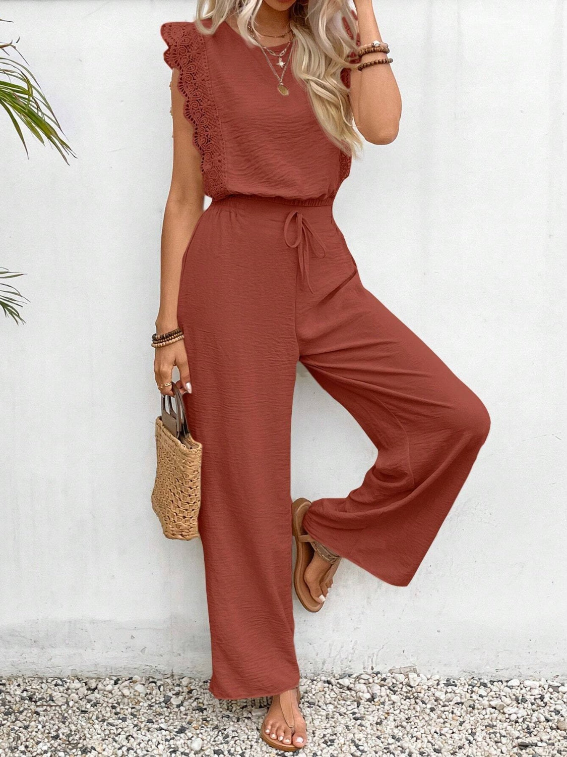 Terracotta textured ruffle sleeve drawstring jumpsuit with wide legs.