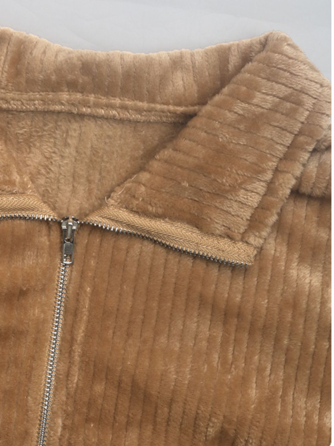 Camel plush corduroy zip-up jacket with fuzzy lining and collared neckline.