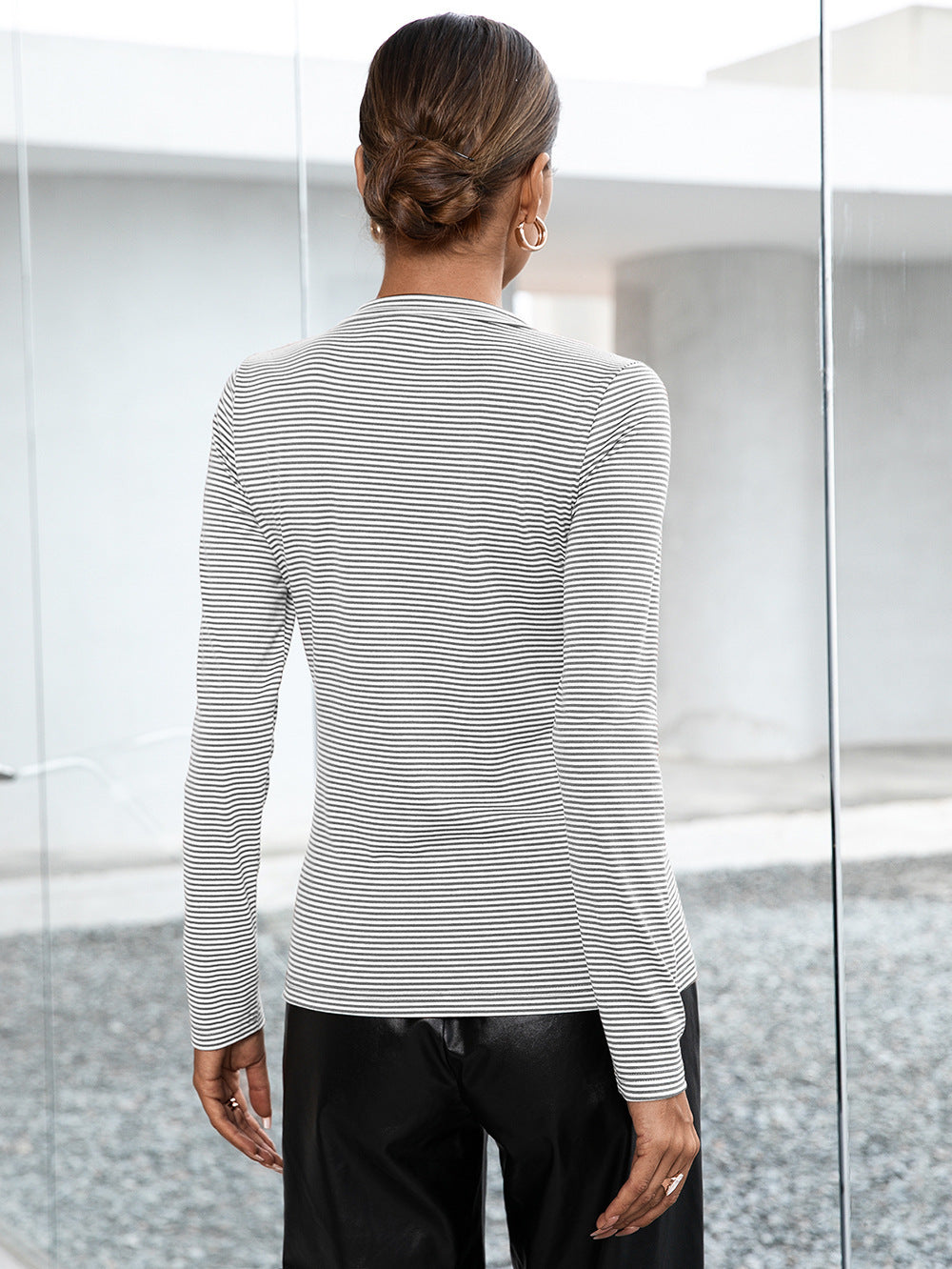 Ribbed Henley stripe top in gray with long sleeves and button detail.