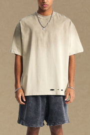 Taupe oversized tee with distressed hemline and neckline details.