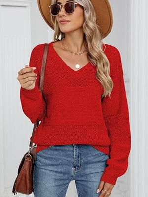 Red diamond eyelet knit V-neck sweater with long sleeves and a relaxed fit.