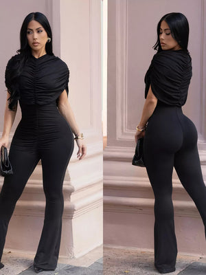 Black ruched romper with cap sleeves and flared legs.