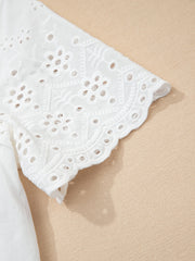 White cotton eyelet embroidered sheer shirt with floral detail and scalloped hem.
