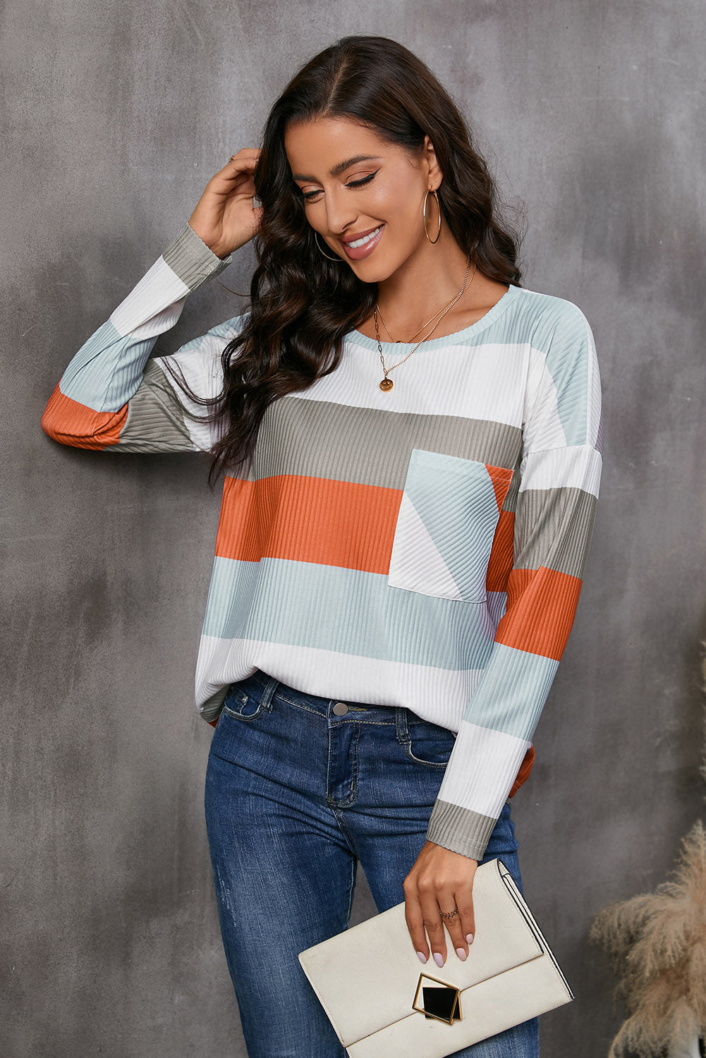 Ribbed stripe long sleeve top with patch pocket in multicolor stripes.