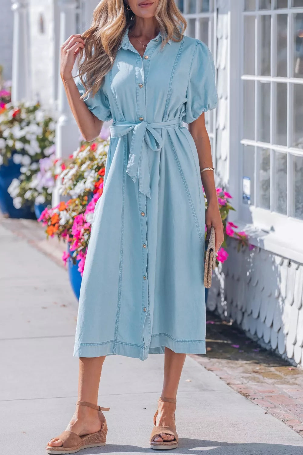 Light blue denim midi dress with collar, short puff sleeves, button front, and tie belt.