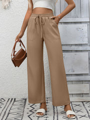 Khaki drawstring wide-leg pants with pockets and a relaxed fit.