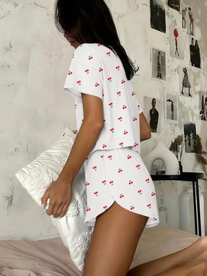 White cherry print pajama set with short sleeves and shorts.