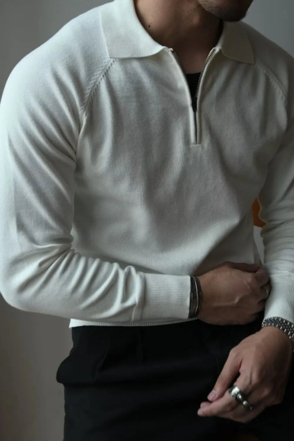 Ivory knit polo with zip-through neckline and raglan sleeves.