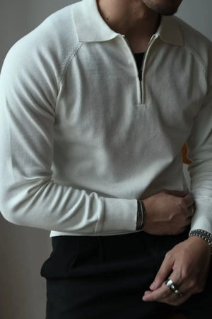 Ivory knit polo with zip-through neckline and raglan sleeves.