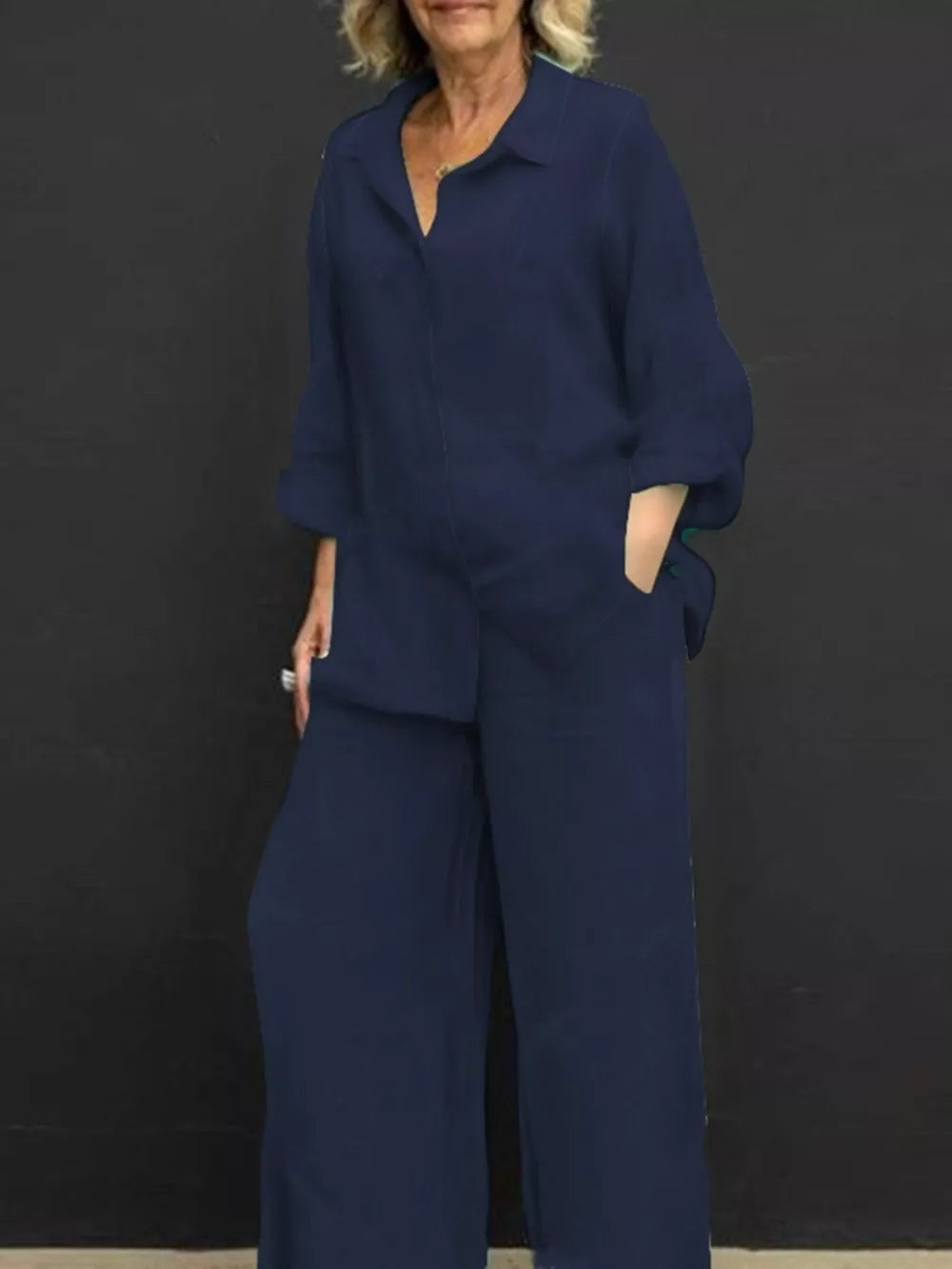 Navy blue relaxed two-piece set with buttoned collared top and wide-leg pants.