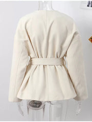 Beige belted trench coat with dropped shoulders and tie waist detail.