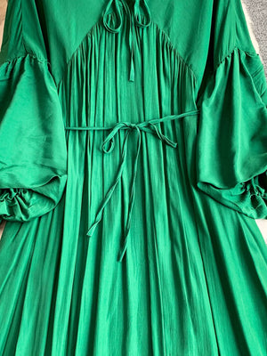 Green polyester maxi dress with balloon sleeves, tie neck, and cinched waist