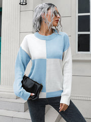 Colorblock knit sweater with pastel blue and white squares, crew neck, long sleeves.