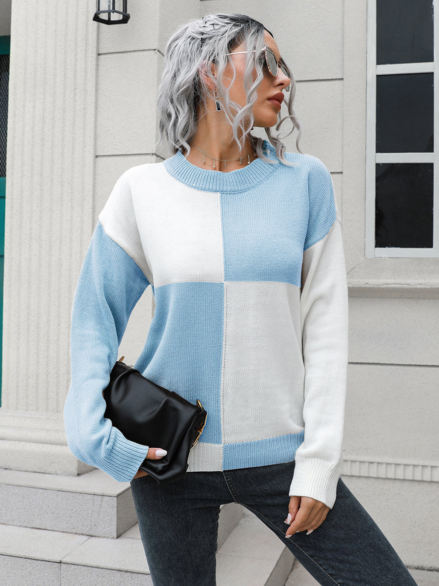 Colorblock knit sweater with pastel blue and white squares, crew neck, long sleeves.