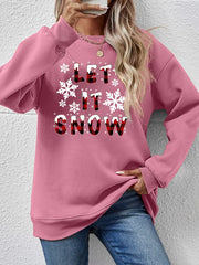 Blush pink crewneck sweatshirt with "Let It Snow" graphic and snowflakes.