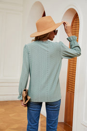 Perforated sleeve blouse in Gum Leaf with ruffle cuffs and lace trim neckline.