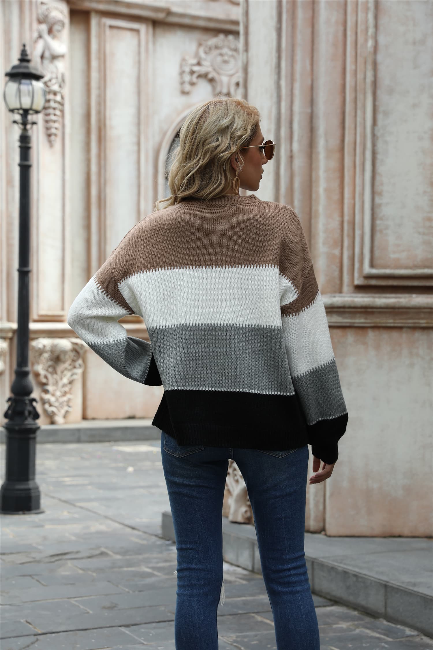 Acrylic crewneck sweater with horizontal color blocks in brown, white, gray, and black.