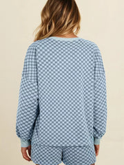 Light blue checkerboard loungewear set with pullover and shorts.