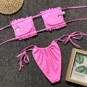 Pink bandeau bikini set with ruffle trim and tie sides.