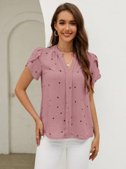 Dusty pink blouse with black heart print, puff sleeves, and V-neck