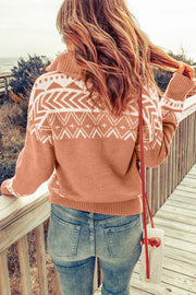 Geometric knit zip-neck pullover in rust with white pattern, featuring a cozy knit texture and a shawl collar.