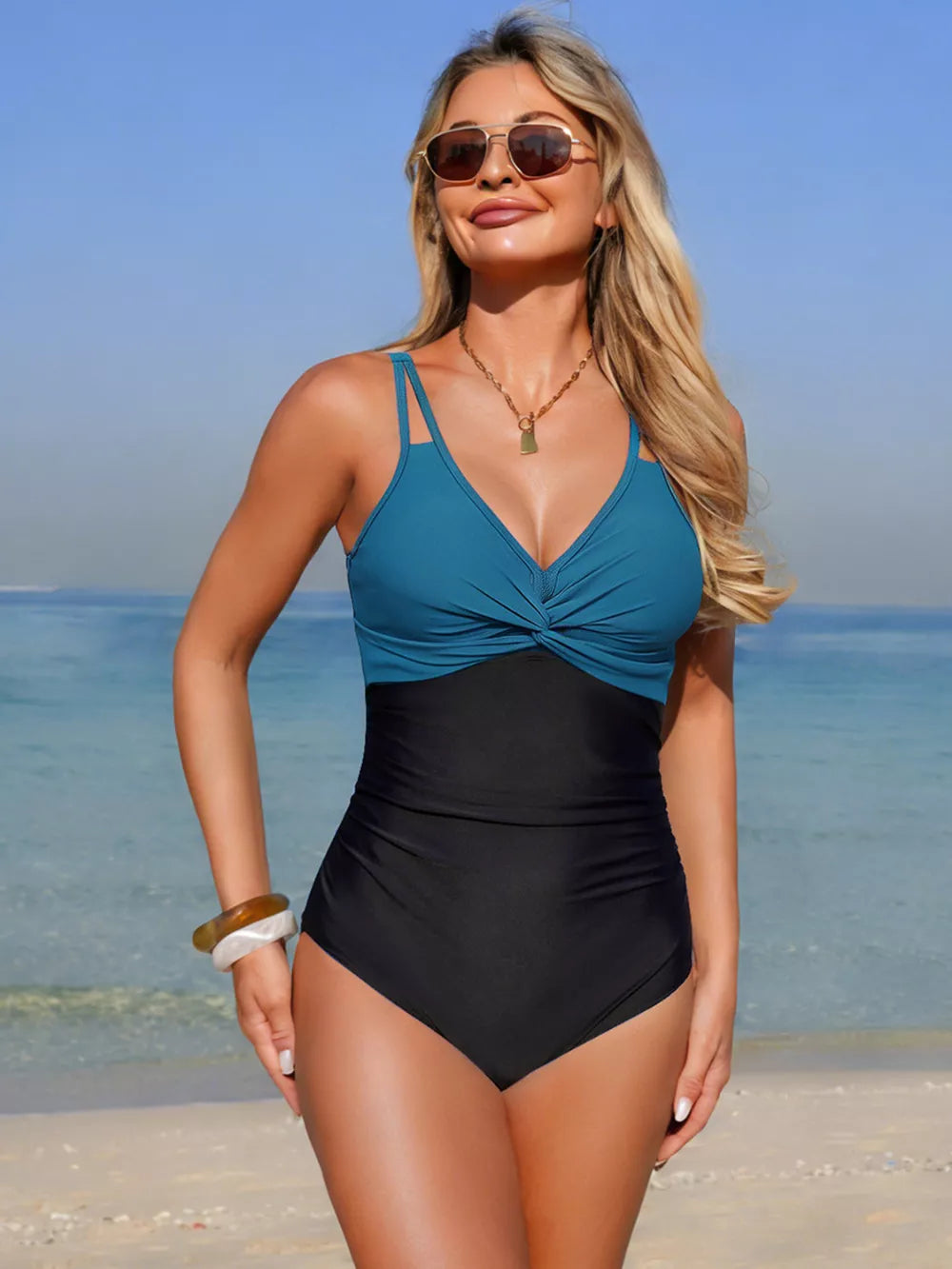 Chic twisted V-neck one-piece swimsuit in peacock blue and black with a flattering cut.