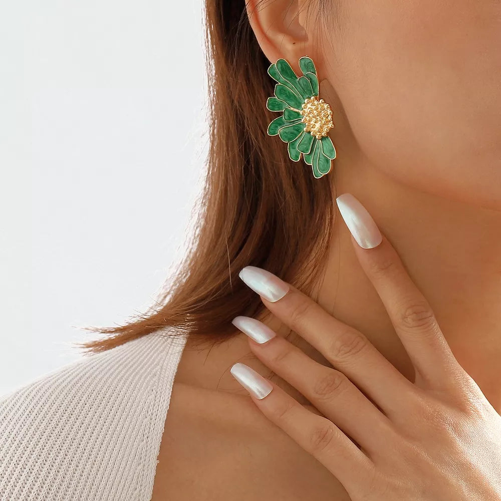 Textured green flower stud earrings with gold center detail.