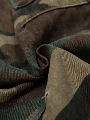 Men's distressed camouflage cargo pants detail showing fabric texture and stitching.