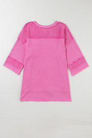 Fuchsia pink waffle knit top with raw seam details and a relaxed fit.