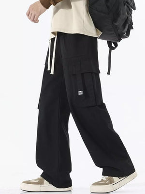 Black cotton cargo sweatpants with wide legs and drawstring waist.