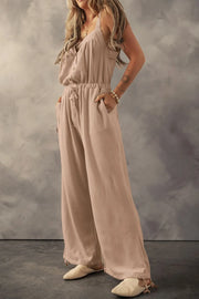 Waffle knit wide leg jumpsuit in khaki with button front, drawstring waist, and pockets.