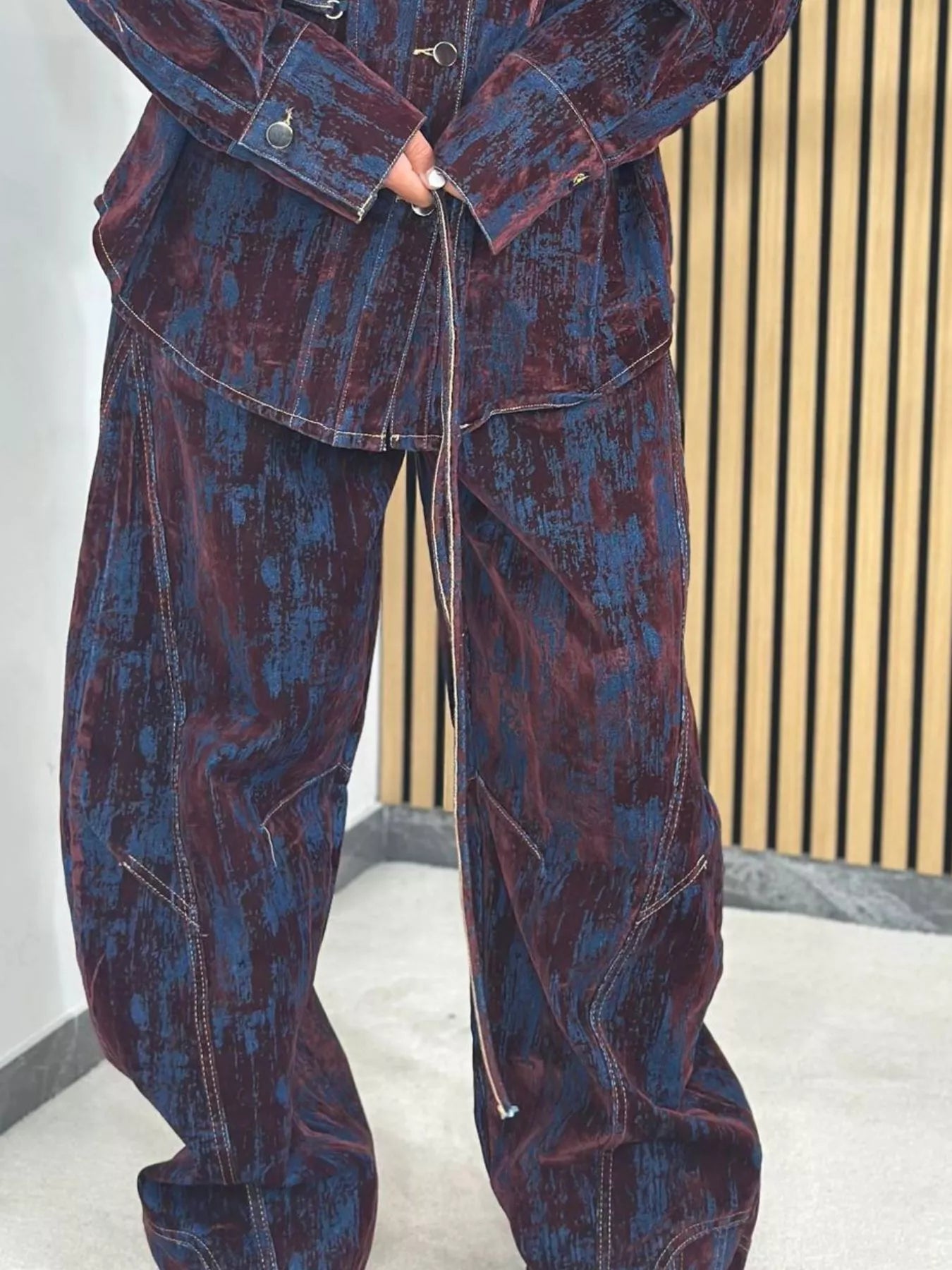 Denim jacket and pants set in burgundy and dark blue with a distressed print and contrast stitching.