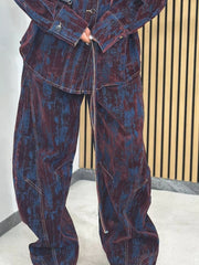 Denim jacket and pants set in burgundy and dark blue with a distressed print and contrast stitching.