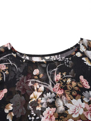 Sheer black floral print round neck blouse with draped details.