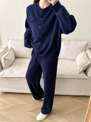 Dark blue ribbed knit cardigan and wide leg pants set with button closure and chest pocket.