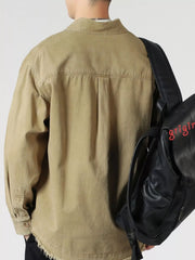 Khaki oversized button-up long-sleeve shirt with frayed hem detail.