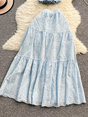 Light blue eyelet maxi skirt with tiered ruffles and elastic waistband.