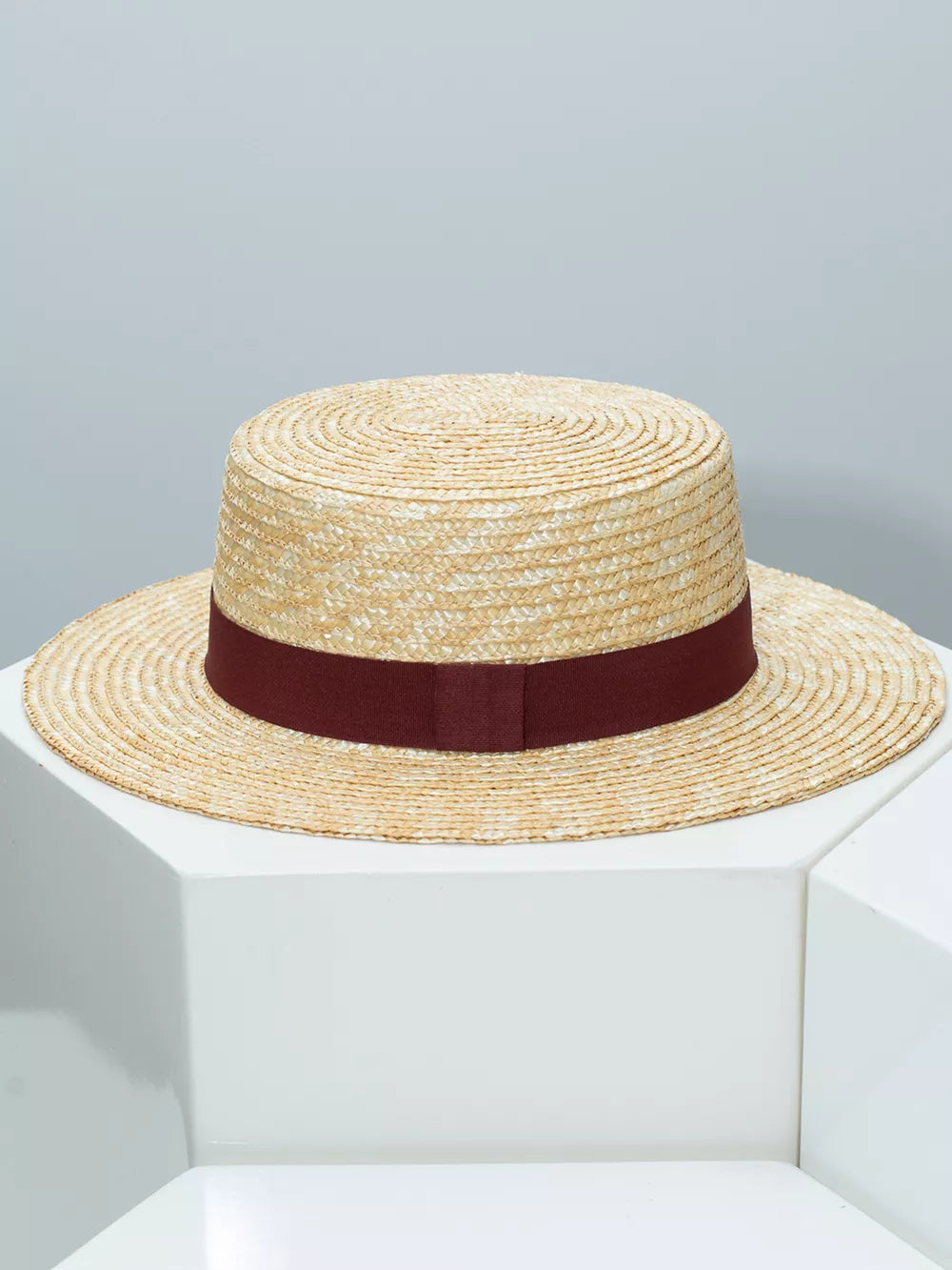 Women's straw boater hat with a wine red ribbon band