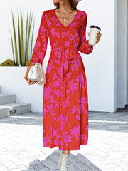 Tiered floral midi dress in hot pink and red with a tie waist and V-neck.
