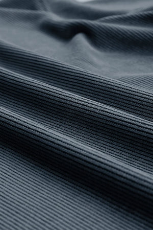 Deep teal ribbed crewneck sweatshirt with a textured fabric detail