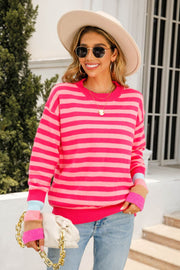 Fuchsia and pink striped acrylic sweater with colorblock cuffs.